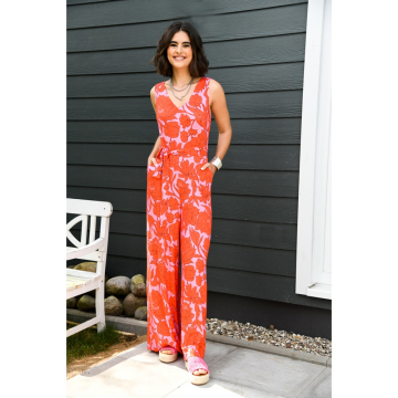 roze stretch tricot stof met oranje bloem dessin