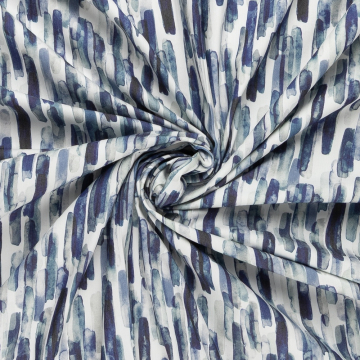 gebroken wit stretch denim stof met batik blauw vegen dessin