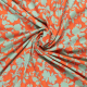 oranje satijnen stof met mintgroen abstract bloemdessin