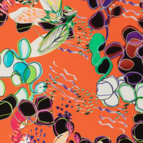 oranje stretch tricot stof met ecru, groen, zwart abstracte bloemen Italiaans import