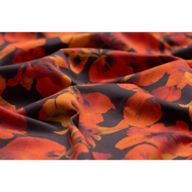 Zwart stretch denim stof met oranje gele bladeren