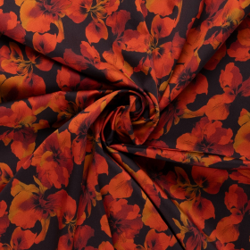 Zwart stretch denim stof met oranje gele bladeren