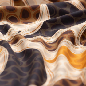 ecru katoenen stof met amber, camel, zwart  fantasie dessin